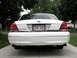 2003 Ford Crown Victoria - The rear of a white 2003 Ford Crown Victoria is shown, dual exhaust pipes and a Wisconsin license plate.