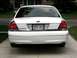2003 Ford Crown Victoria - Rear view of a white 2003 Ford Crown Victoria, dual exhaust pipes and a Wisconsin license plate.