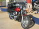 2003 Honda Shadow Aero - A red motorcycle is packed with luggage, parked next to another motorcycle.