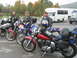2003 Honda Shadow Aero - A group of riders and their motorcycles are parked together, with a bus and truck visible behind them.