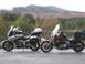 2003 Honda Shadow Aero - Two motorcycles are parked on the side of the road with a scenic mountain backdrop.