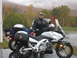 2003 Honda Shadow Aero - A man and two motorcycles are parked on a wet road with autumn foliage in the background.