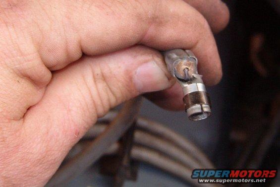 spkplug06.jpg Fold the conductor over the end of the insulation and insert it into the clamp end of the terminal so it presses into the bottom of the channel.