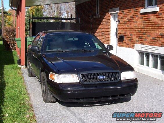 Black 2003 Ford Crown Victoria parked in driveway