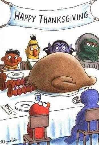 Sesame Street characters gathered around a table with a turkey and a 'Happy Thanksgiving' banner