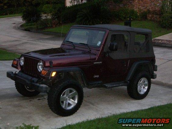 Maroon Jeep Wrangler with soft top, 3/4 front view