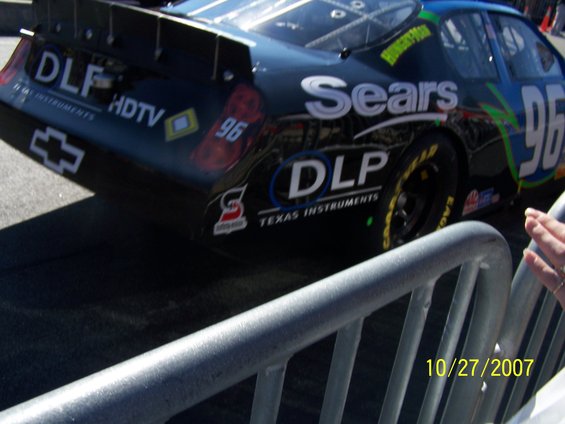 Black NASCAR race car with Sears and DLP logos, rear view