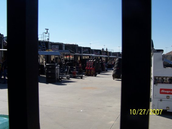 Pit lane scene with garages and equipment, dated 10/27/2007