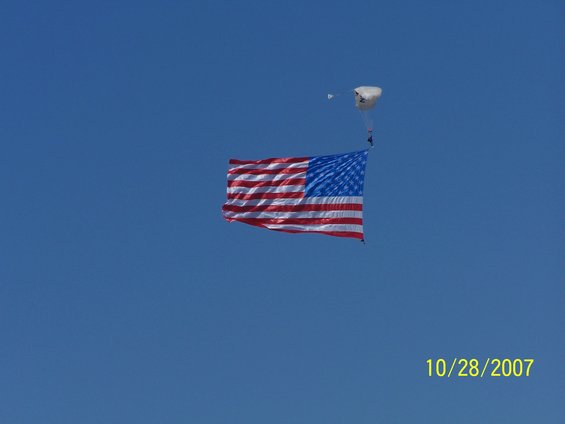 American flag and skydiver against blue sky, dated 10/28/2007