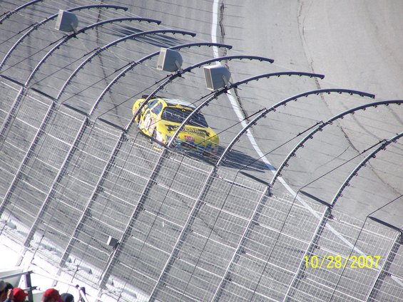 Yellow NASCAR race car on track, date stamp 10/28/2007