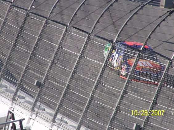 Race car with number 38 on its side, viewed from above on a track