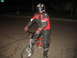 2007 Yamaha R1 - A person dressed in full motorcycle attire is seated on a bicycle at night.