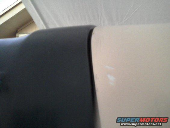 Close-up of black trim next to a cream panel