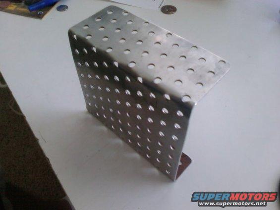 Perforated metal bracket on a white surface