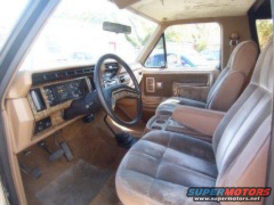 Interior of 1986 Ford Bronco showing dashboard, steering wheel, and seats