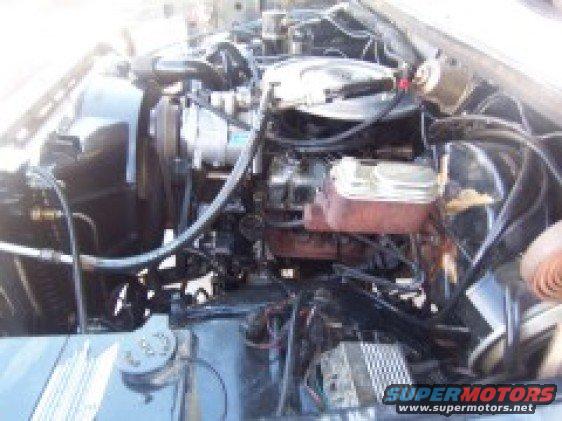 Engine bay with visible radiator, brake fluid reservoir, and wiring
