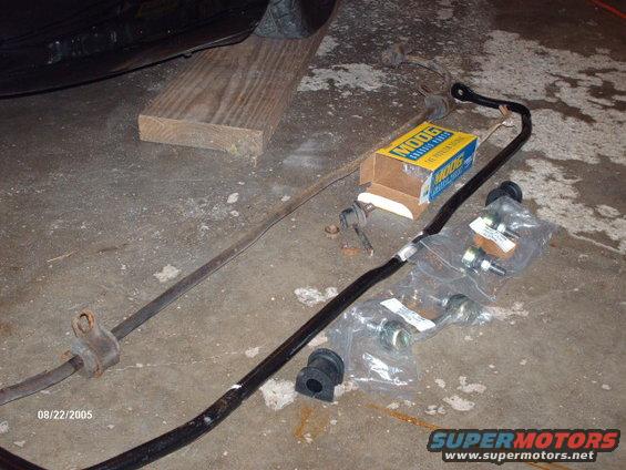 Car sway bars and Moog parts box on concrete floor next to a tire