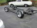 1964 Ford Ranchero - Custom chassis with chrome wheels sits in front of a 1964 Ford Ranchero.