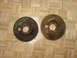 1985 Ford Bronco - Two old Ford brake drums sit on a parquet floor, one marked with 'FORD 9"'.