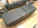 1985 Ford Bronco - Two black Delta storage cases are visible on a wooden floor, with other items in the background.
