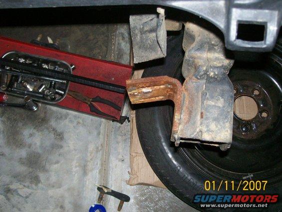 Spare tire with a red toolbox containing pliers and sockets nearby