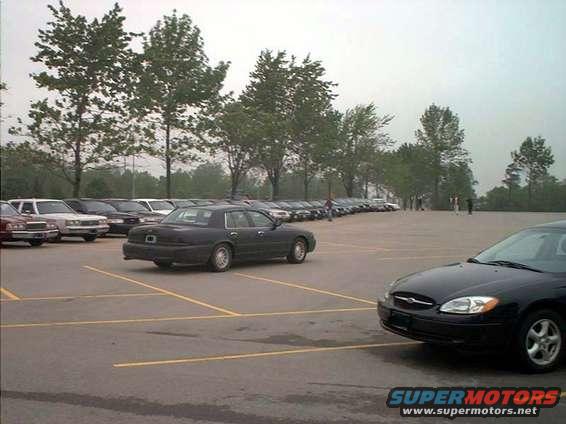 Dark sedan parked in a lot, 2000 Ford Crown Victoria