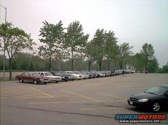 Maroon 1998 Ford Crown Victoria parked in a lot, side view
