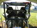 1992 Ford Mustang - The interior of a custom-built off-road vehicle, a roll cage and dual tanks, is viewed from the rear.