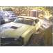 1971 Mercury Cyclone - A weathered 1971 Mercury Cyclone GT sits in a yard with other vehicles and structures visible.
