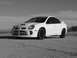 1996 Ford Probe - White Dodge Neon SRT-4 with aftermarket wheels parked outdoors under a cloudy sky.