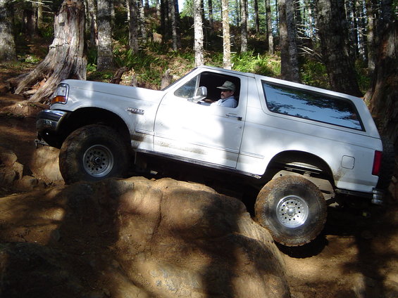 White 1996 Ford Bronco navigating rocky terrain