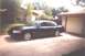 2002 Ford Crown Victoria - Dark blue 2002 Ford Crown Victoria sedan parked on a concrete driveway next to a garage.