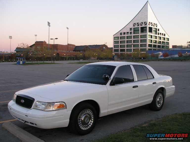 White 2001 Ford Crown Victoria sedan parked in a lot, front 3/4 view