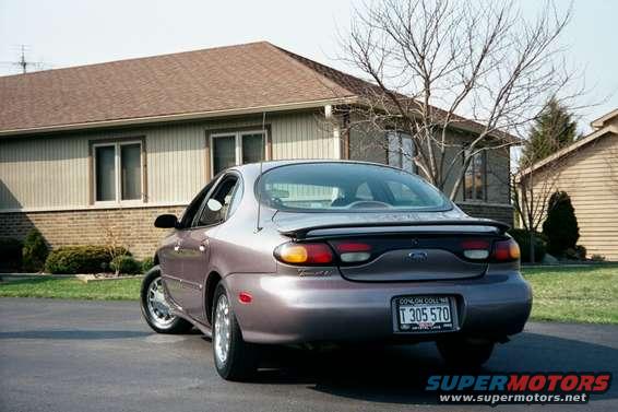 Rear view of a 1996 Ford Taurus parked in front of a house