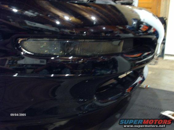 Black car front bumper with clear headlight detail