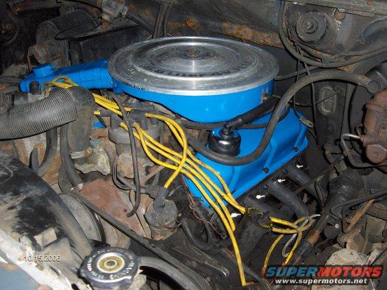 Engine bay with blue valve covers, yellow spark plug wires, and air cleaner