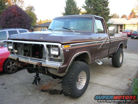 1978 Ford F-250 pickup truck, front end removed, on jack stands. Brown paint with chrome trim