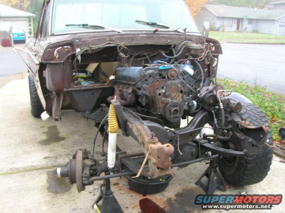 Front end of a disassembled 1978 Ford F-250 truck, engine out, sitting on jack stands