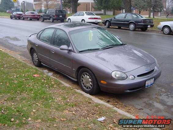 Gray 1996 Ford Taurus parked curbside, front 3/4 view