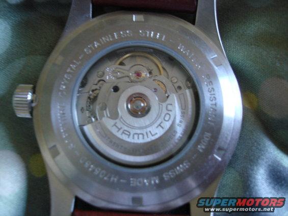 Hamilton watch movement visible through case back, with stainless steel band