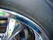 1999 Ford Mustang - A close-up view of a chrome wheel and tire, with some text visible on the tire's sidewall.