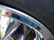 1999 Ford Mustang - Detail of a chrome wheel and tire, with some text visible on the tire sidewall.