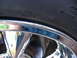 1999 Ford Mustang - A close-up view of a tire and a chrome rim, showing some sidewall markings.