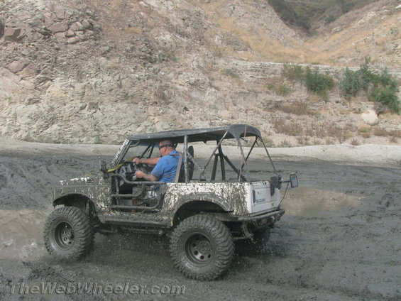 1987 Suzuki Samurai driving through mud