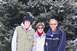 1996 Ford Taurus - Family poses for a photo in front of snow-covered pine trees during winter.