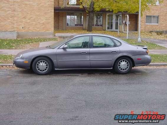 Gray 1996 Ford Taurus sedan parked on a street, side view