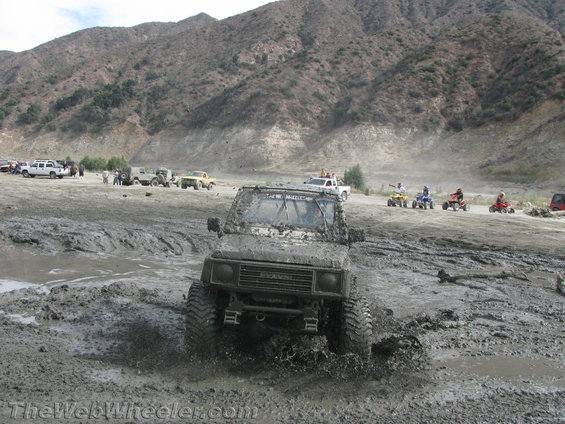 1987 Suzuki Samurai driving through mud