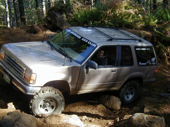 Ford Explorer on a rocky trail, with a "BIG BRONCOS 4X4 CLUB" sticker on the windshield