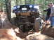 1989 Ford Bronco - A modified 1992 Ford Bronco navigates a challenging off-road trail with onlookers observing.