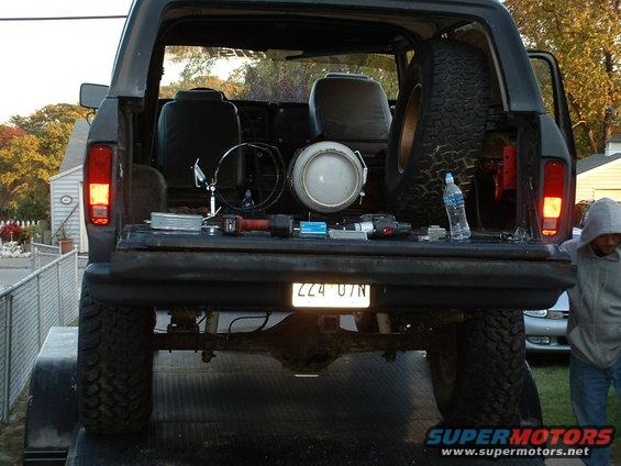1978 Ford Bronco tailgate open, showing spare tire, seats, and tools